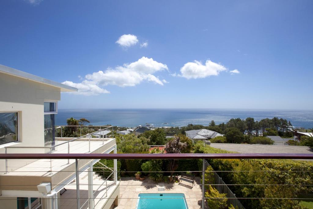a view of the ocean from the balcony of a house at Entabeni Guest House in Cape Town