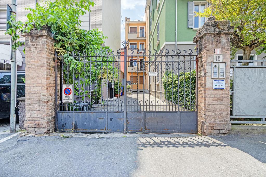 an iron gate in front of a building at Clelia Apartments in Parma
