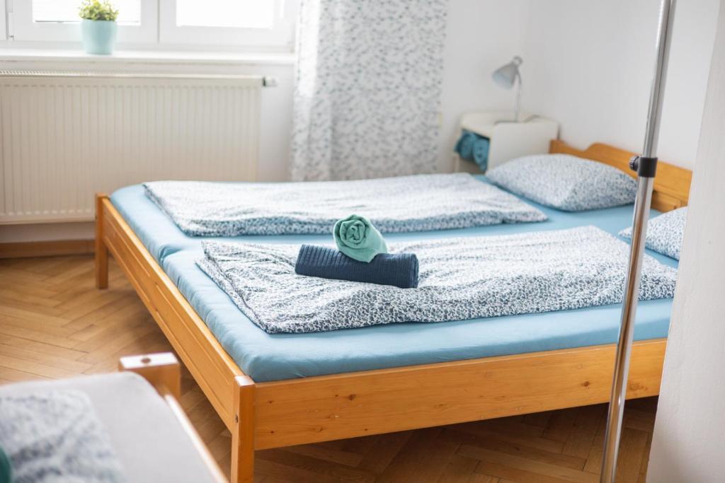a bedroom with two beds with blue sheets at Apartmán U Šálků in Znojmo