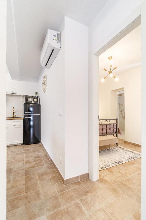 a kitchen with white walls and a refrigerator at Josipa in Supetar