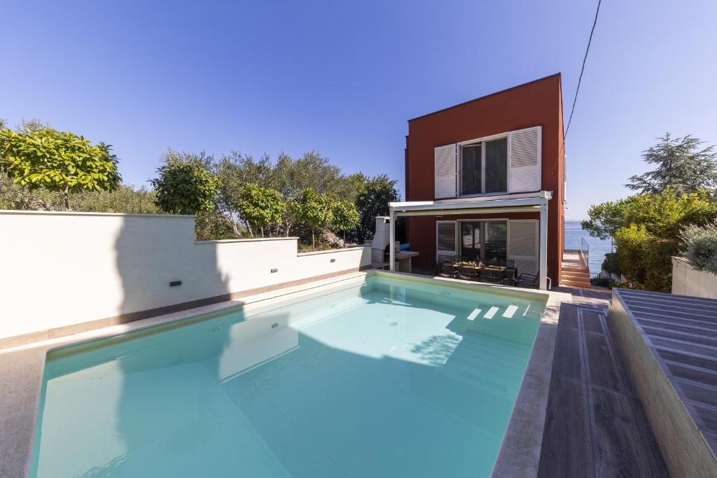 a swimming pool on the roof of a house at Karmen Adriatica in Kukljica