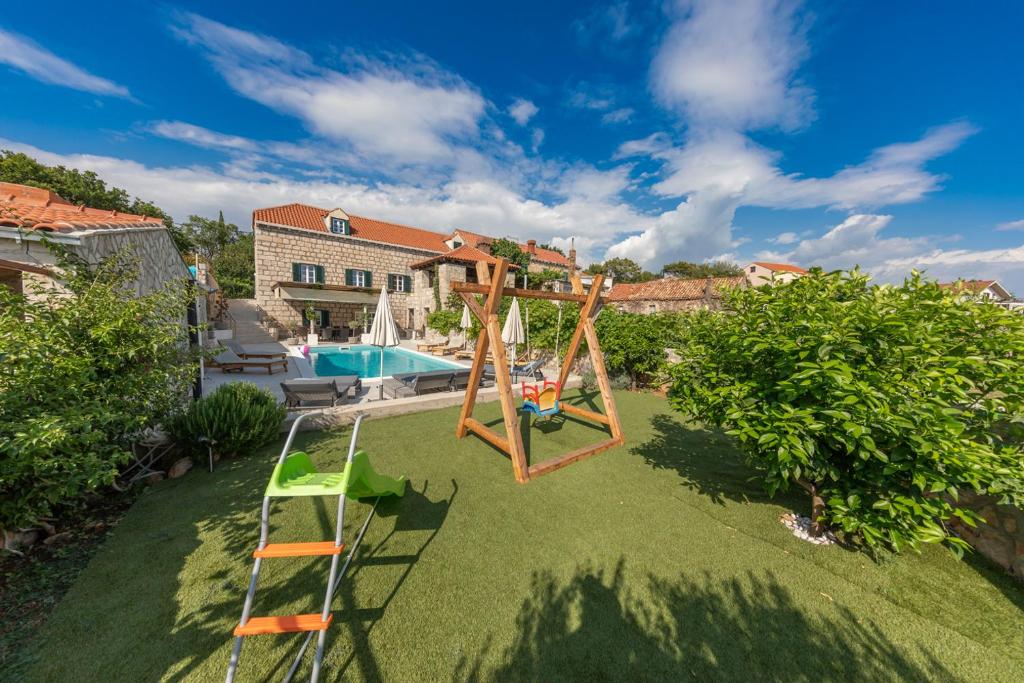 an aerial view of a yard with a playground and a pool at Joe in Čilipi