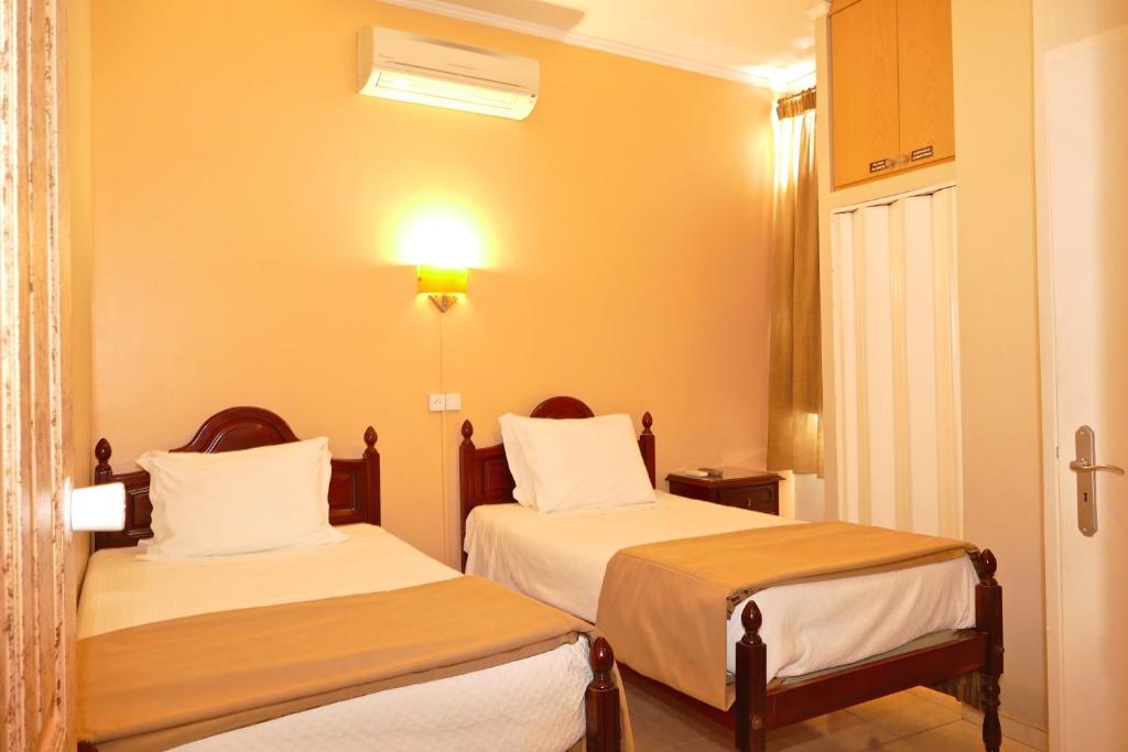 Postel nebo postele na pokoji v ubytování Guest House Sao Filipe