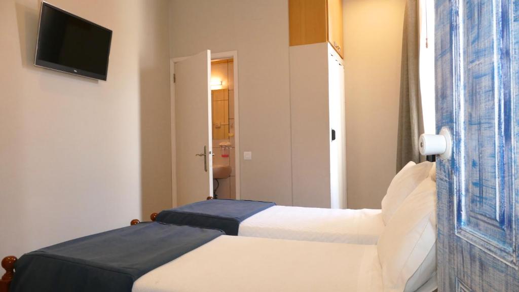 Postel nebo postele na pokoji v ubytování Guest House Sao Filipe