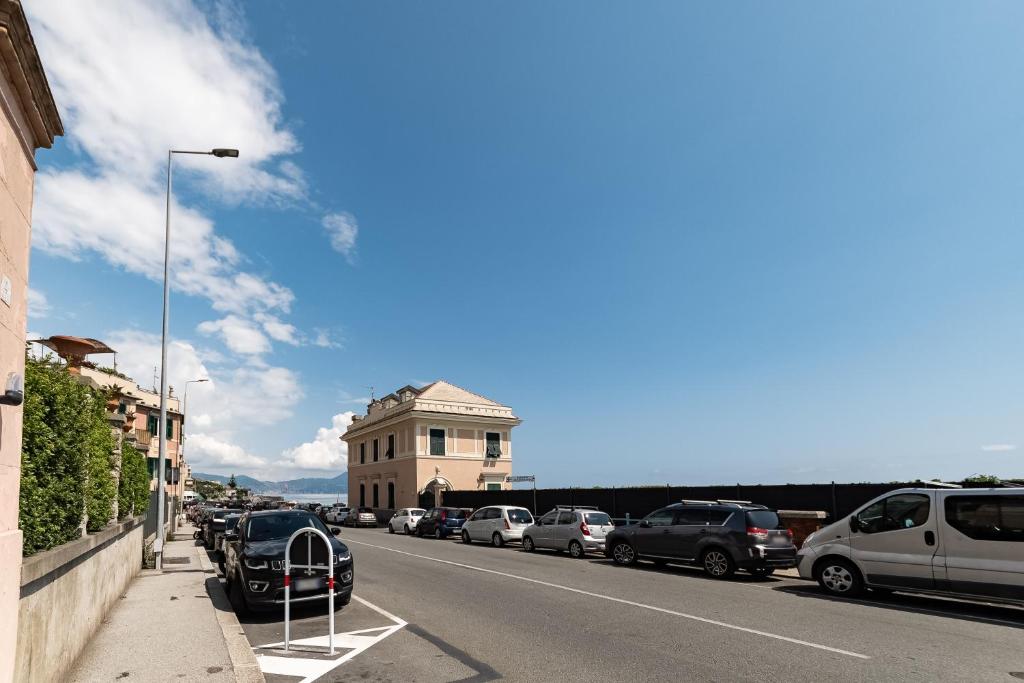 a city street with parked cars and a building at Sea Loft Quinto - A due passi dal mare in Genoa