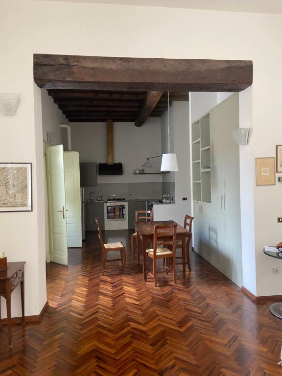 a kitchen and dining room with a table and chairs at Casa Bonacini in Reggio Emilia