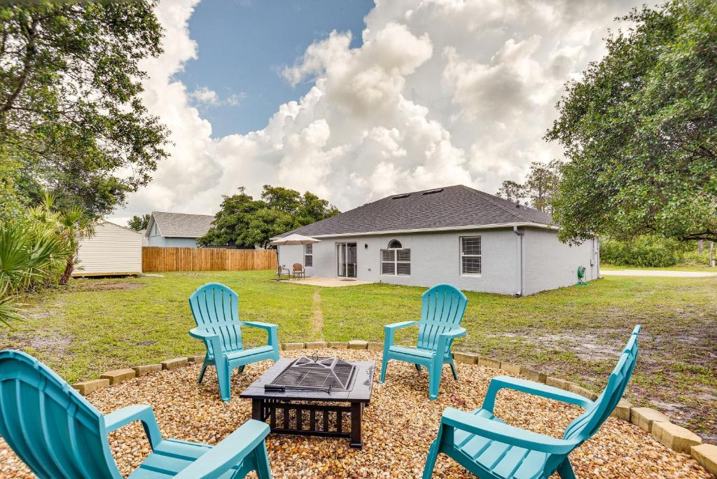 a group of chairs and a table in a yard at Palm Coast Vacation Rental about 8 Mi to Flagler Beach in Flagler Beach