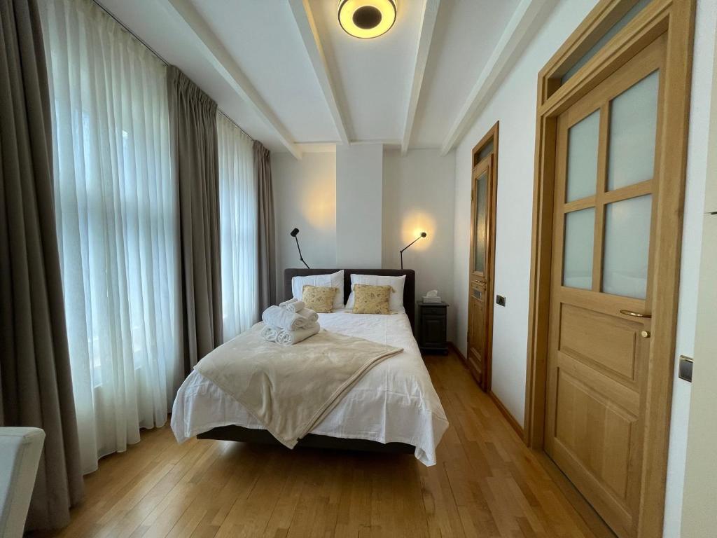 a bedroom with a bed with white sheets and a ceiling at Amsterdam-bnb in Amsterdam