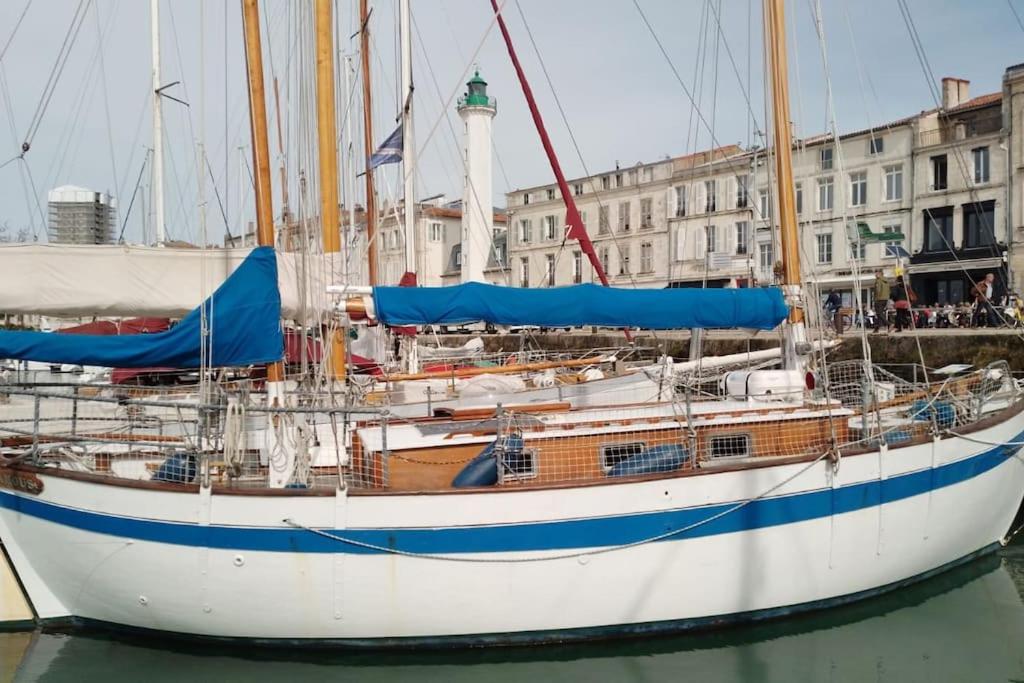 a boat sitting in the water in a harbor at Superbe vieux greement a La Rochelle in La Rochelle