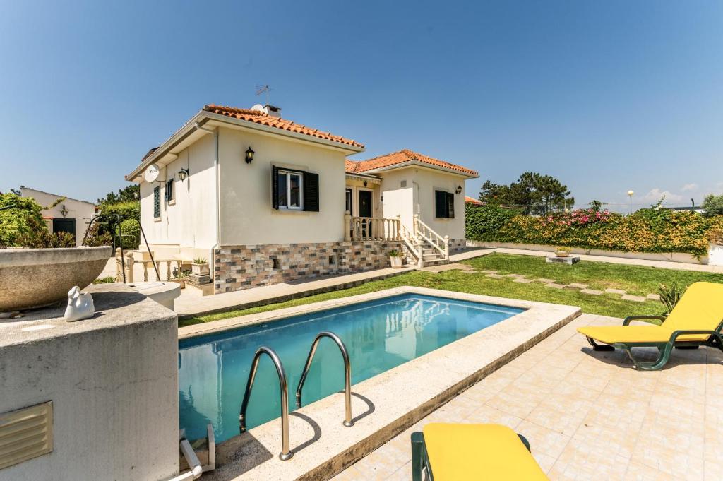 a villa with a swimming pool and a house at BmyGuest - Lagoa Beach & Pool Villa in Lagoa de Albufeira