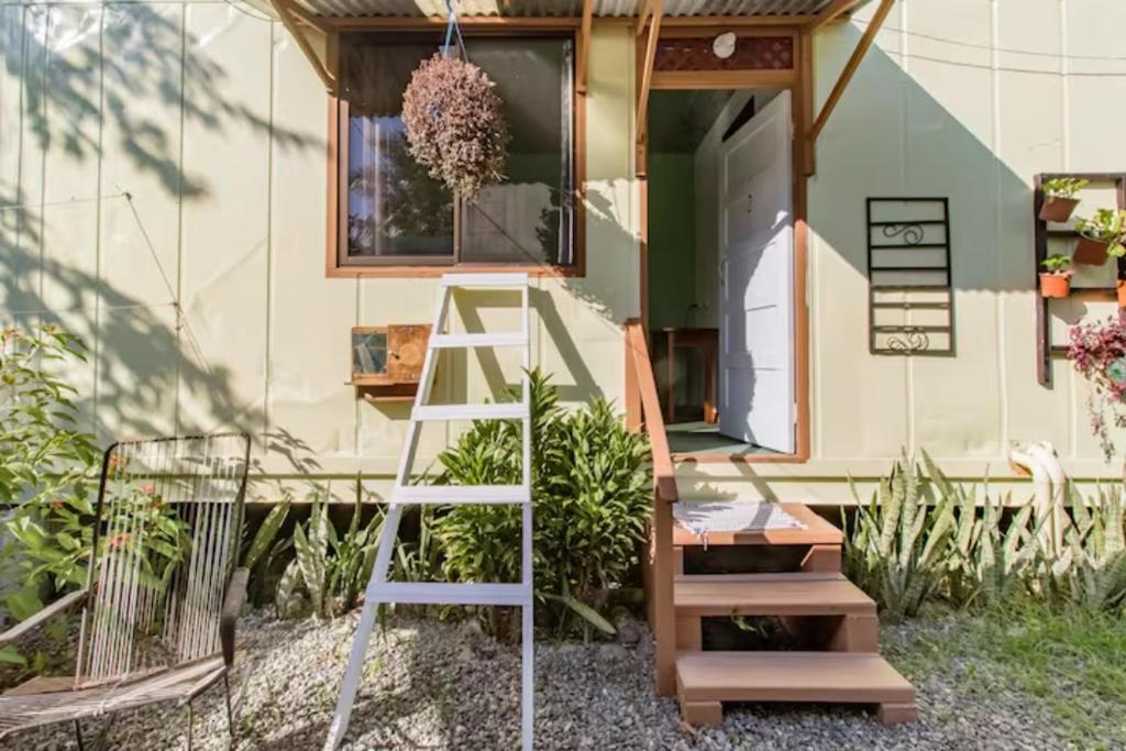 a ladder in front of a tiny house at Container House Cahuita in Cahuita