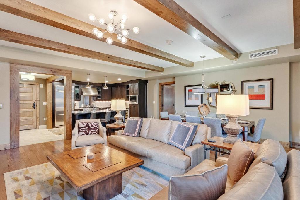 a living room with a couch and a table at Edgemont 2306 - Luxury Condo - True Ski-in Ski-out Access & Winter Shuttle! in Steamboat Springs