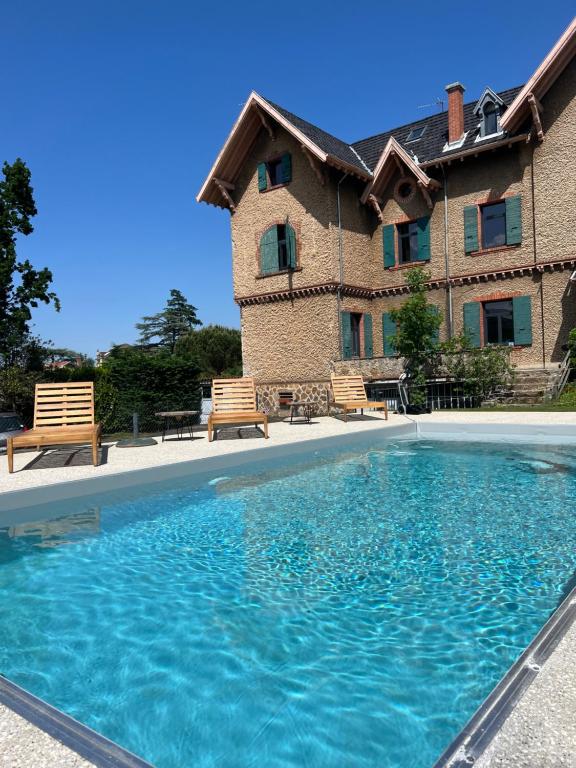 a large swimming pool in front of a house at O'Cottage double in Annonay