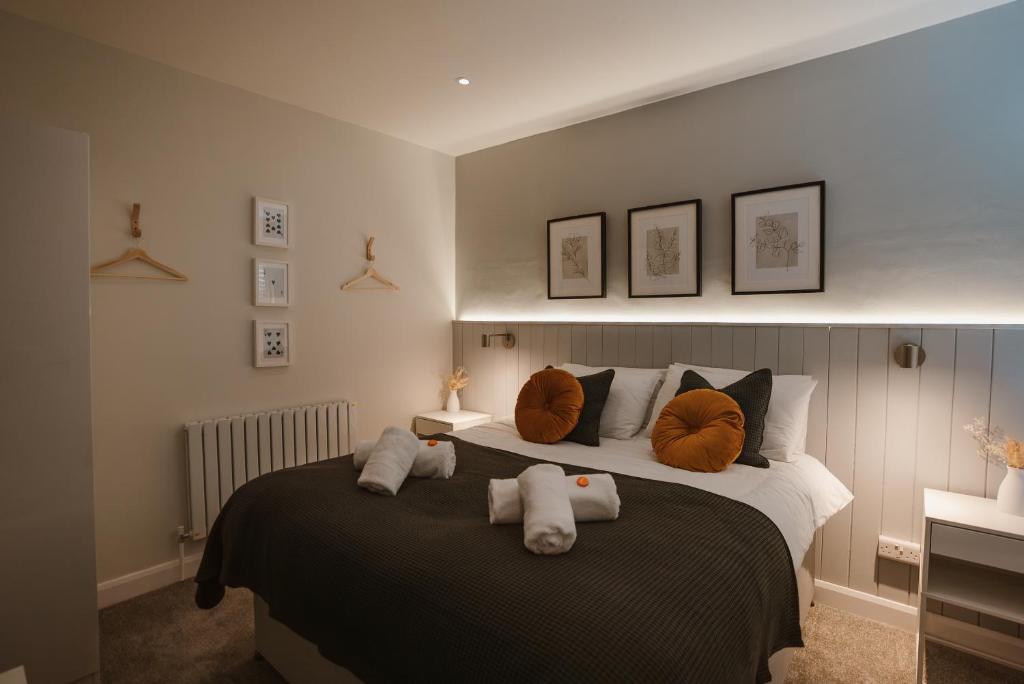 a bedroom with a bed with two stuffed animals on it at Blooms Apartment in Marple