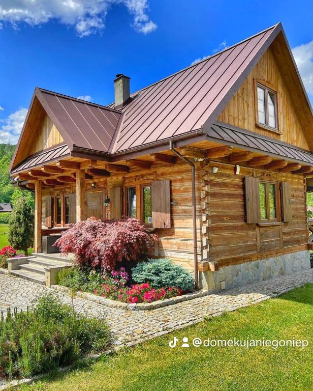a log cabin with a metal roof at Domek u Janiego in Milówka