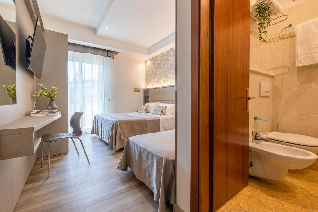 Postel nebo postele na pokoji v ubytování Hotel Cavour
