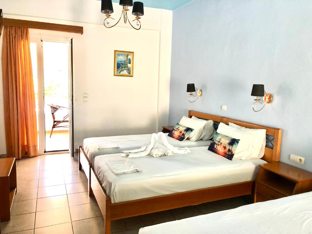 a bedroom with two beds in a room at Villa Marianna in Parga