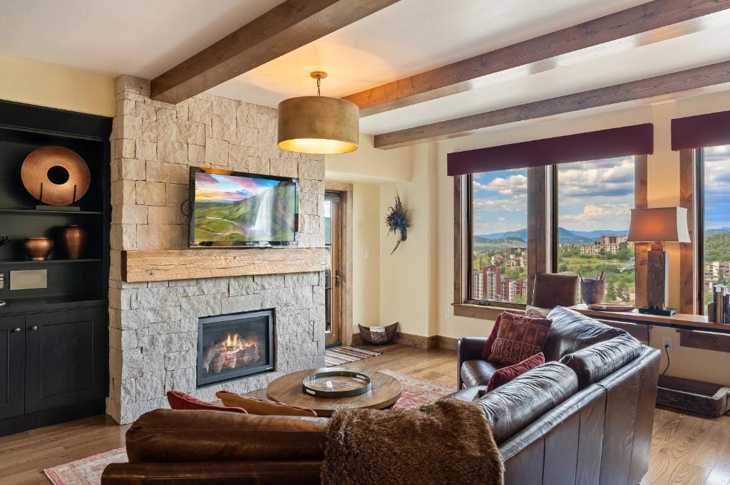 a living room with a couch and a fireplace at Edgemont 2605 - Luxury Ski-in Ski-out Condo in Steamboat Springs