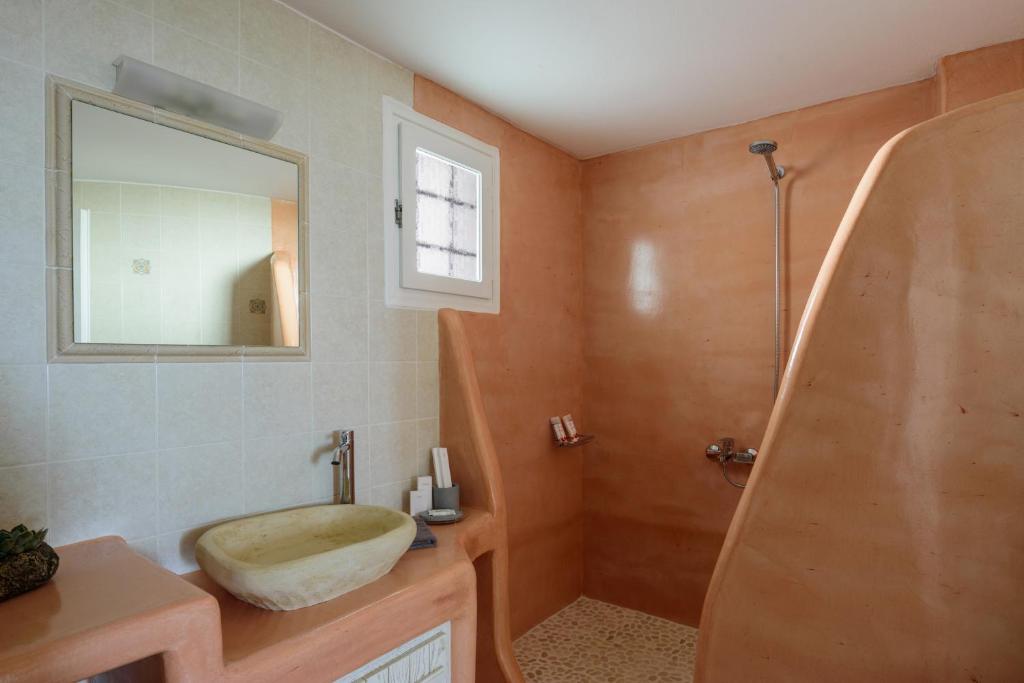 a bathroom with a sink and a mirror and a shower at CASA ARISTA in Fira