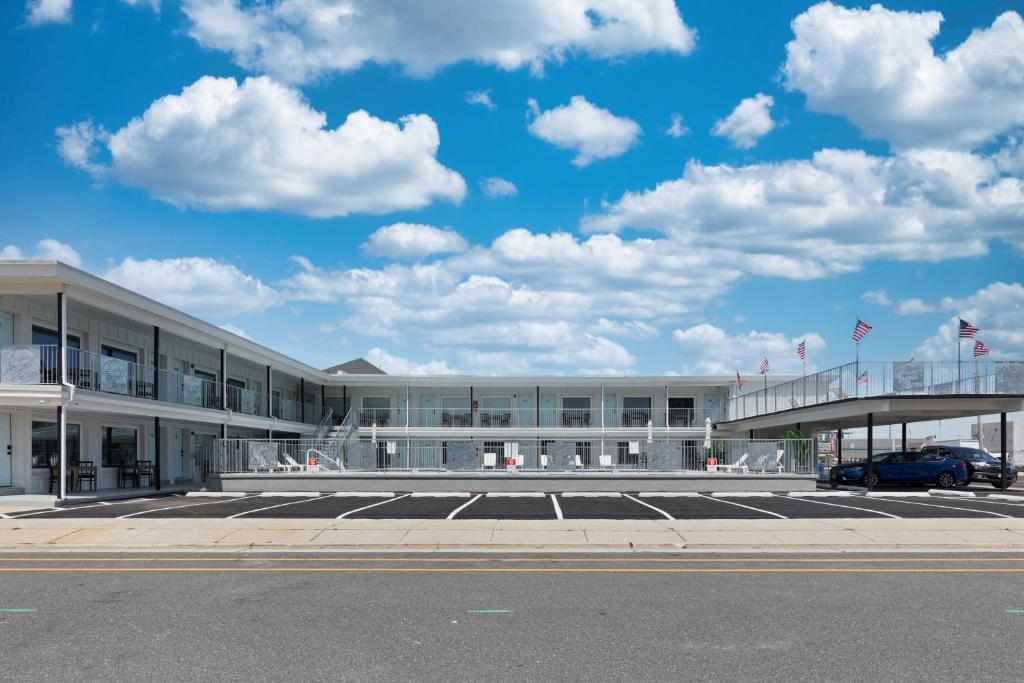 a building with a car parked in a parking lot at The Beach House in Wildwood