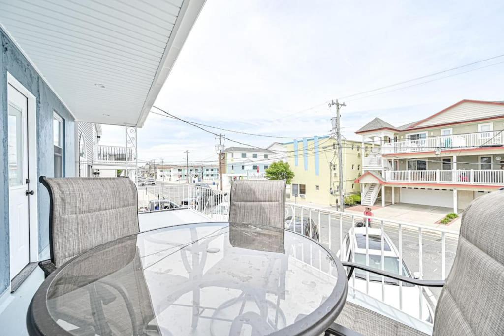a glass table and two chairs on a balcony at 318 E Youngs Ave Unit 5 Salty Shore Oasis Spectacular Retreat in Wildwood