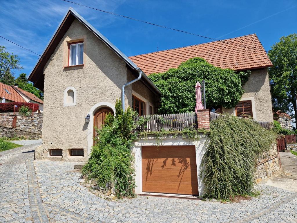 a house with a large garage in front of it at Amazing 5 bedroom house KRUMLOV 82 - 4 min walk to main square in Český Krumlov