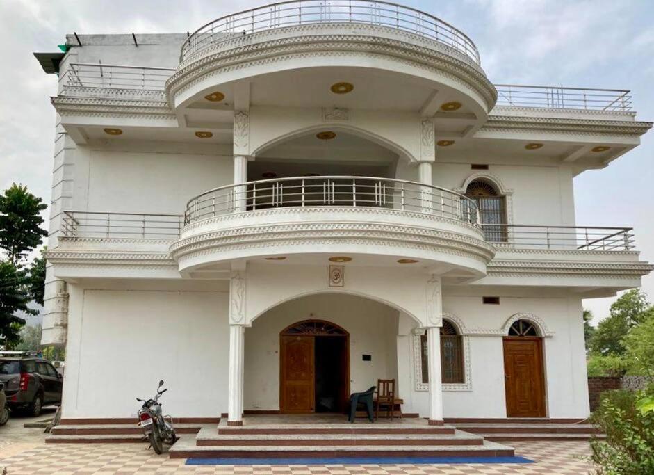a large white building with a balcony on top of it at Lagnalaya- Your Next Home in Rājgīr