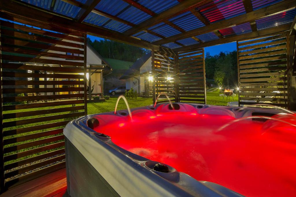 a red bath tub sitting under a roof at Domki i tyle in Rabka