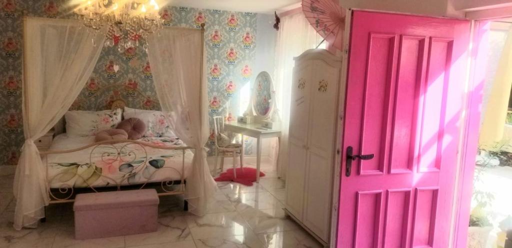 a baby sleeping in a crib in a room with a pink door at ViLLETTA CLAUDETTA in Laveno-Mombello