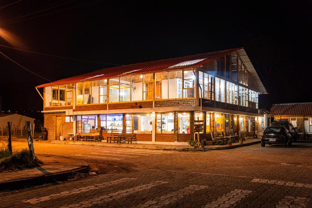 a building at night with a car parked in front of it at Ilinizas Mountain Lodge in Chaupi