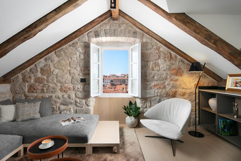 - un salon avec un mur en pierre dans l'établissement Villa Lapisa, à Dubrovnik