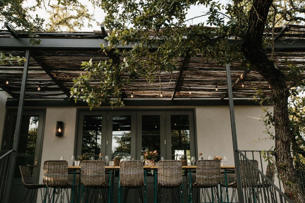 a table and chairs on a porch with a table and chairs at The Wayback Boutique Hotel in Austin