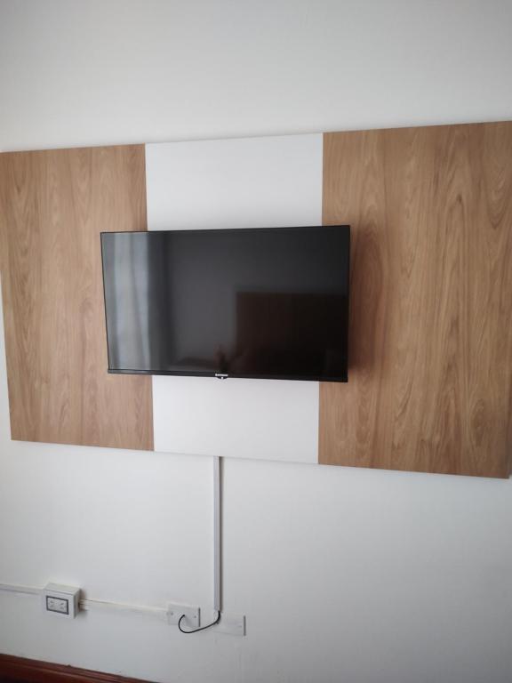 a flat screen tv hanging on a wall at Bienestar Haedo in Mariano J. Haedo
