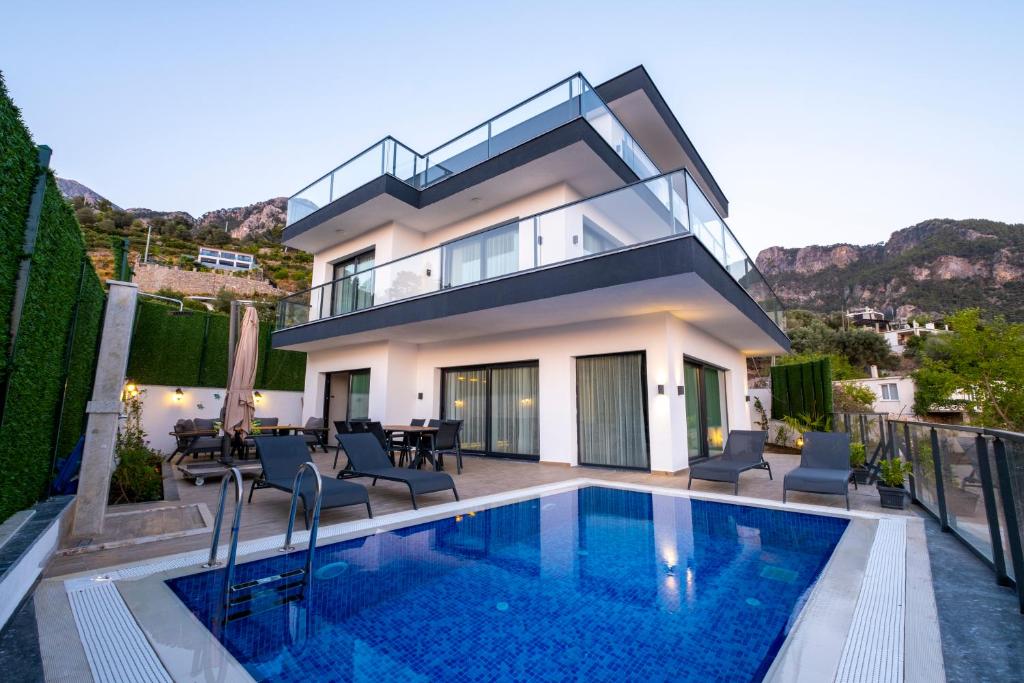 a villa with a swimming pool and a house at Villa Butterfly in Fethiye
