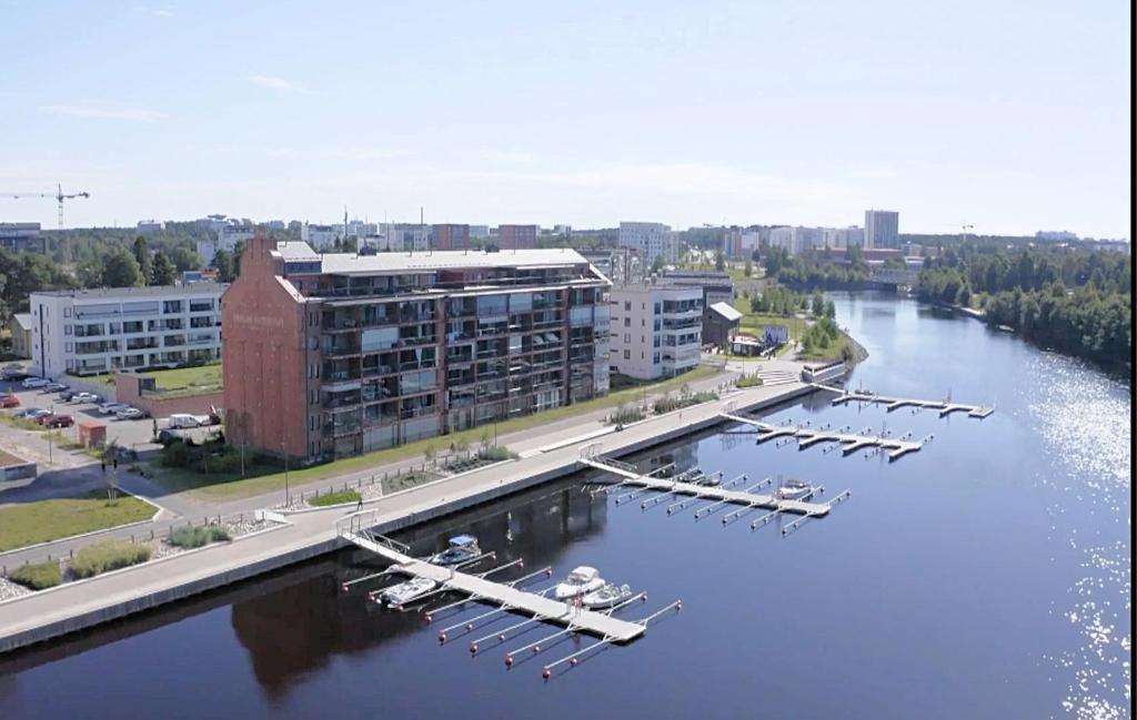 a group of boats are docked in a river at Toppilansalmi two bedroom apartment with a view in Oulu