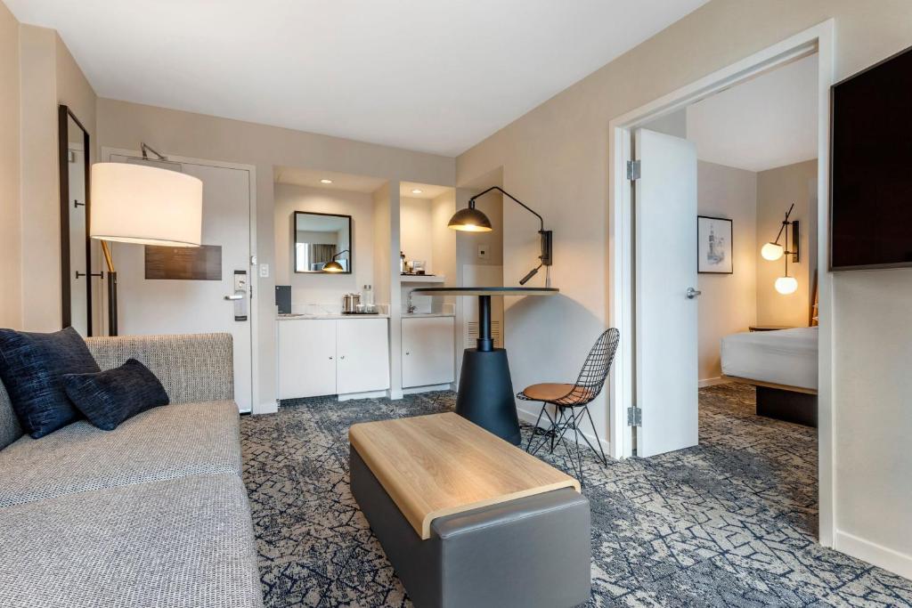 a living room with a couch and a table at Sheraton Suites Old Town Alexandria in Alexandria