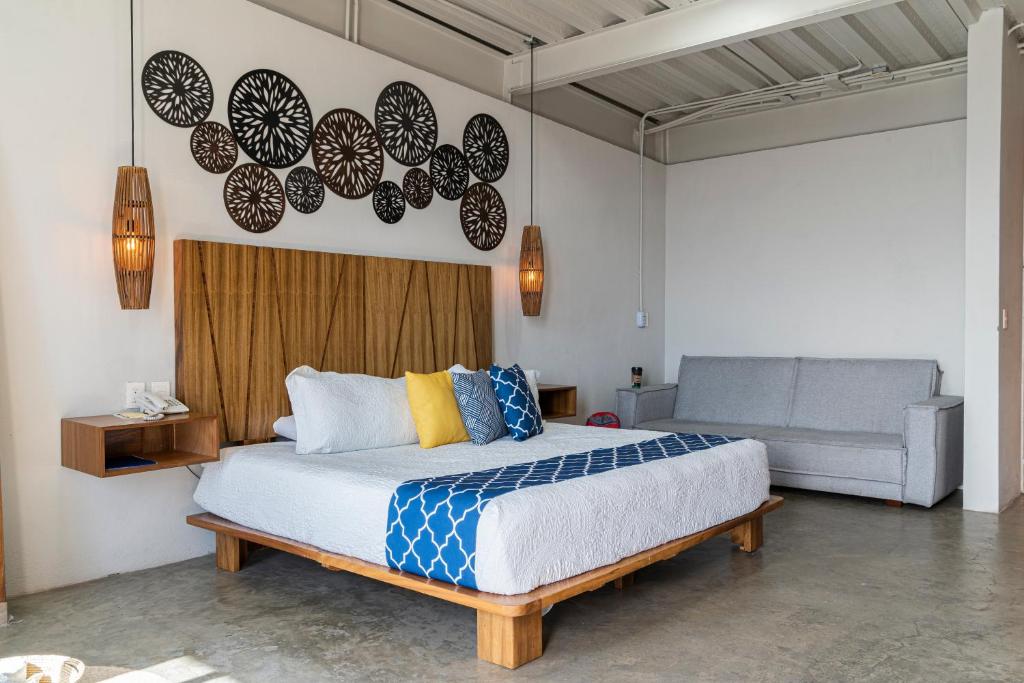 a bedroom with a bed and a couch at Hotel Boutique Marrakesh in Villa Corona