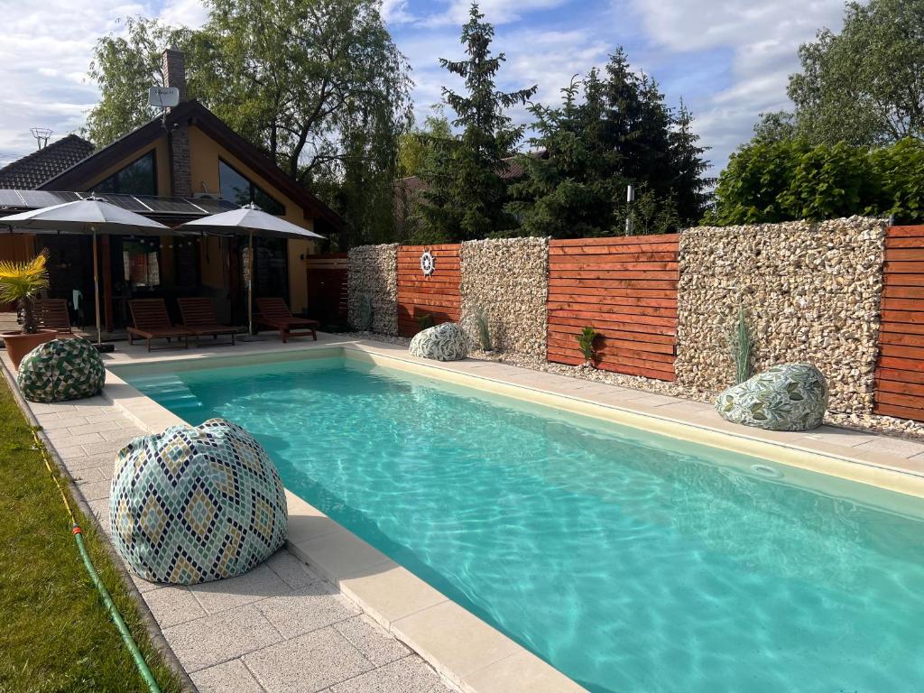 a swimming pool in front of a house at Paradise Resort in Miercurea-Ciuc