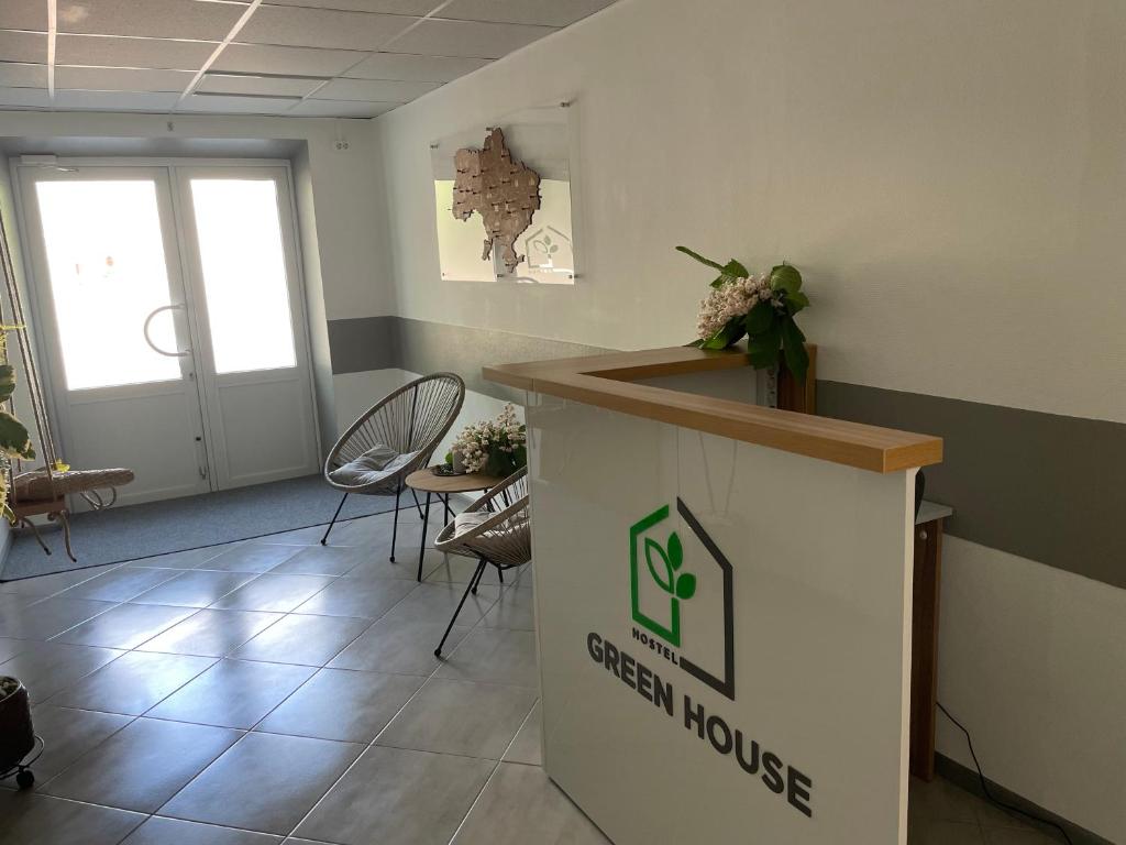 a waiting room with chairs and a reception counter at Хостел Житомир GREEN HOUSE in Zhytomyr