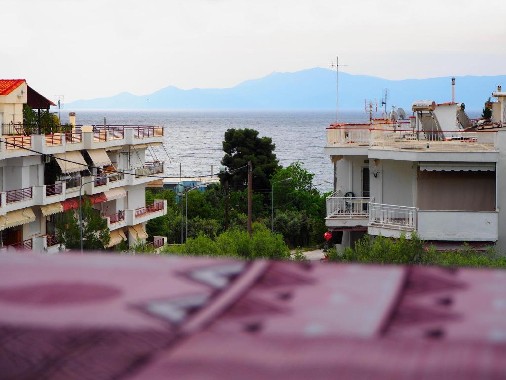 a view of a body of water with two buildings at Dimitris apartment in Paleo Tsifliki