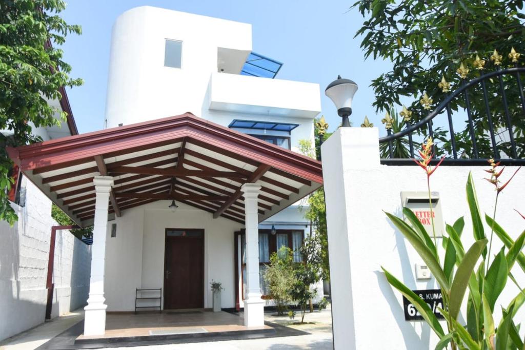 a house with awning in front of it at Sanmi Home Rentals Battaramulla in Battaramulla