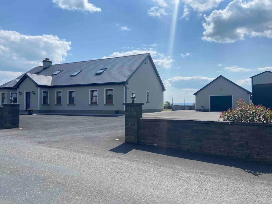 a large white building with a parking lot at Shannon Breeze lodge in Kilrush