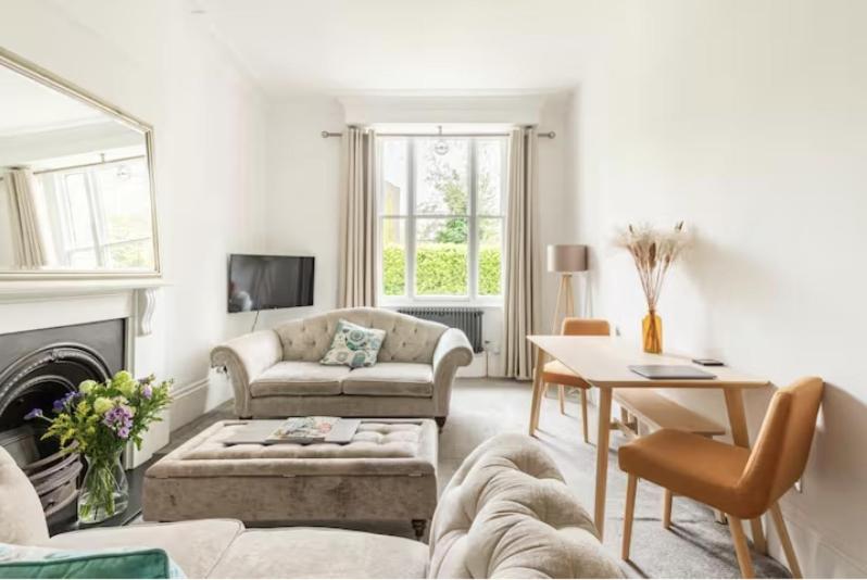 a living room with a couch and a table at Spacious 1 bed in Primrose Hill in London
