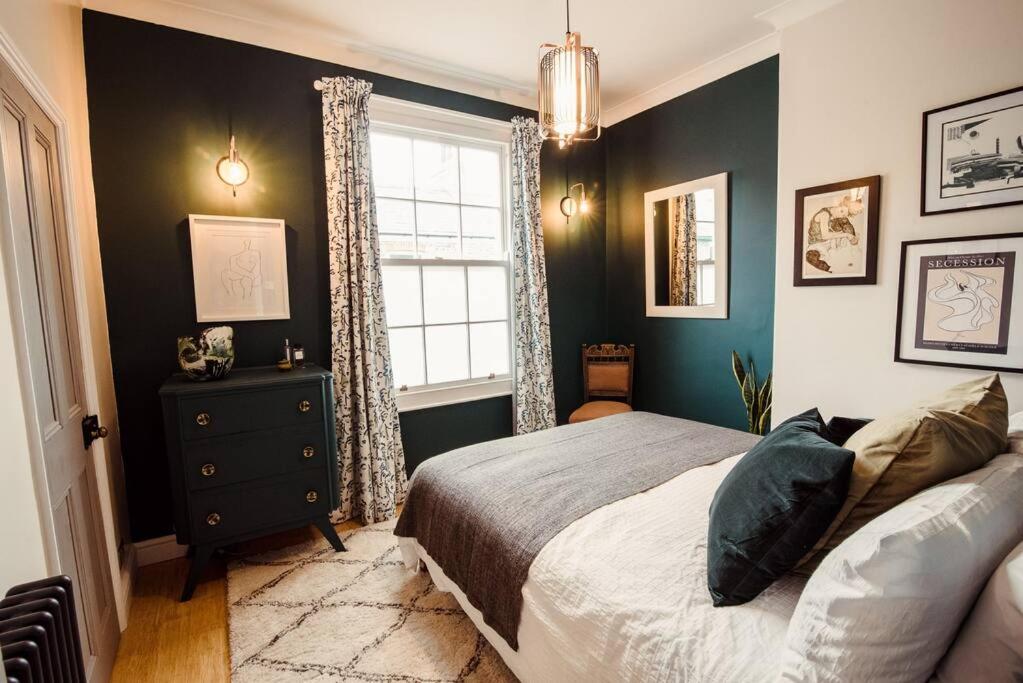 a bedroom with a bed and a window at Artistic hideaway within York’s ancient city walls in York