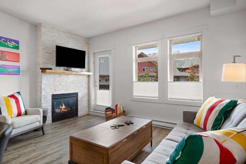 a living room with a couch and a fireplace at Beautiful Renovated Wolf 2Bed 2Bath in Canmore