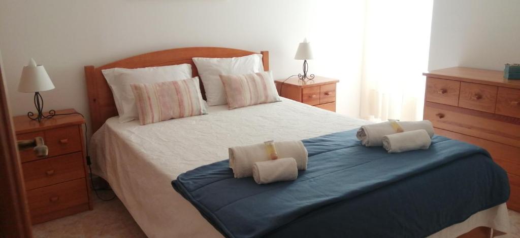 a bedroom with a large bed with two pillows on it at Maré Alta by CS in Olhos de Água
