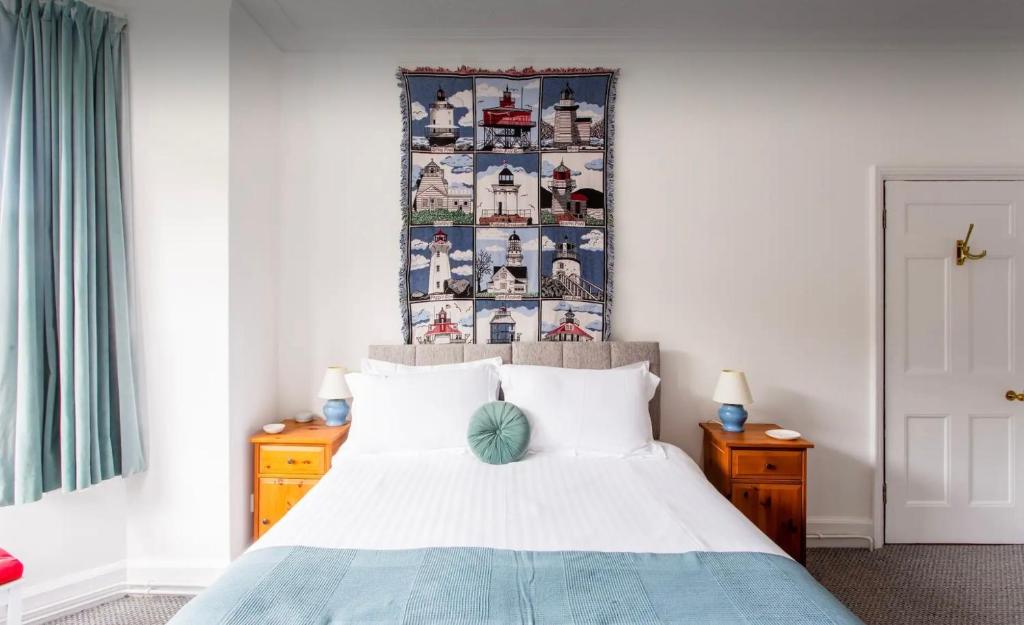 a bedroom with a bed and a wall with pictures at Brackenbury House in Portland