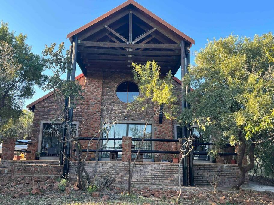 a large brick house with a gambrel roof at Hakuna Matata-Bela Bela in Moheme