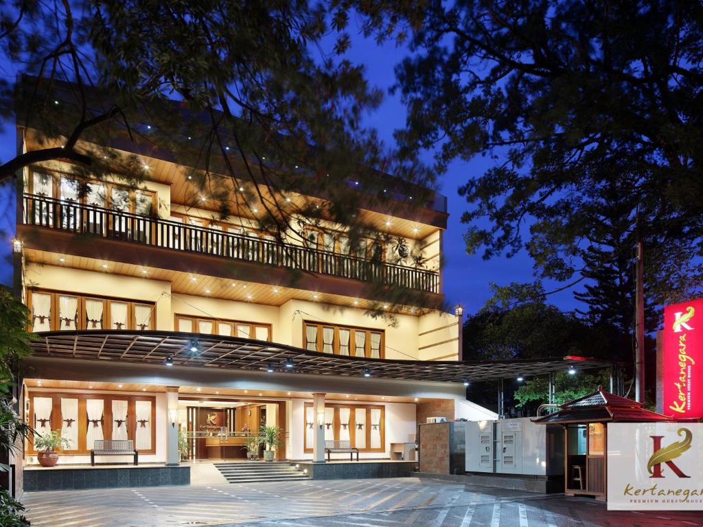 a large building with a balcony on top of it at Kertanegara Premium Guest House in Malang
