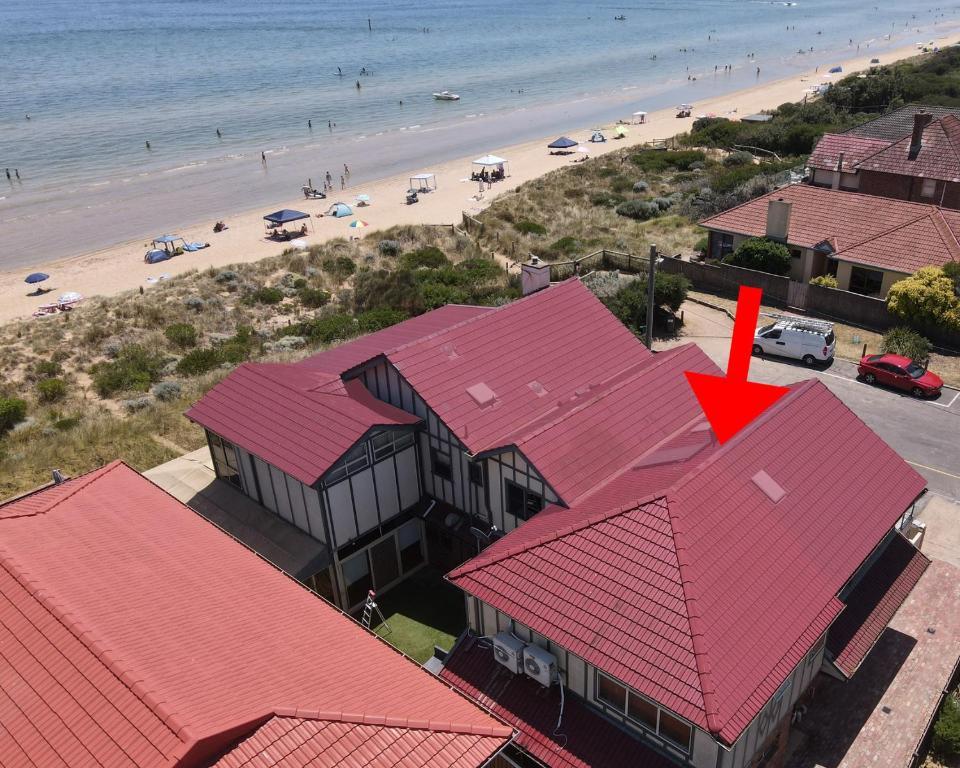 an aerial view of a beach with red roofs at On The Beach, Kids & Pets Friendly in Frankston